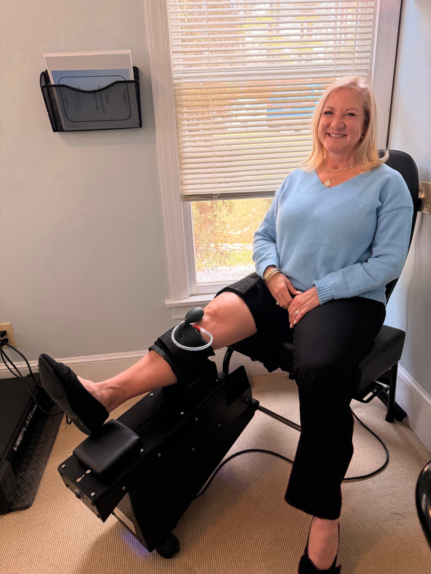 Client seated comfortably during a knee decompression session at Allt House